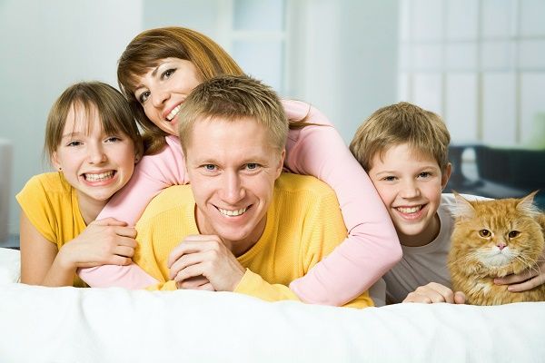 Family of four on a bed